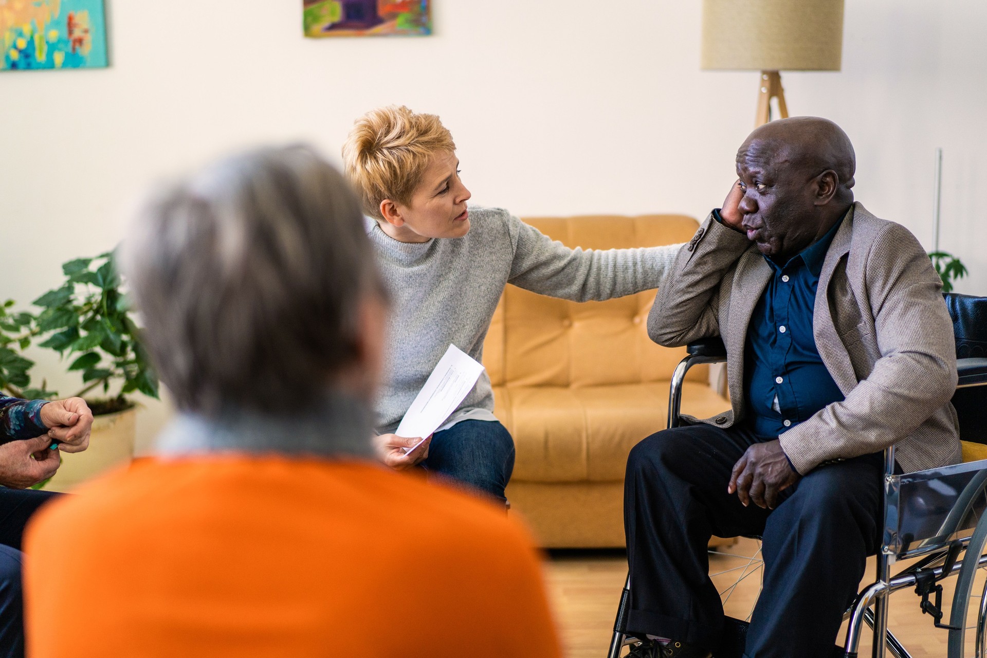 A caring therapist is touching a patients shoulder offering support