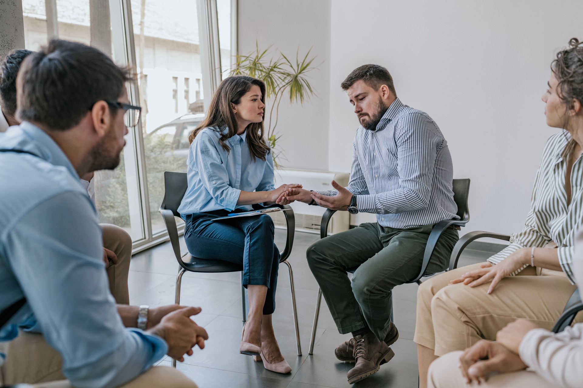 Group psychotherapy session in a modern office setting